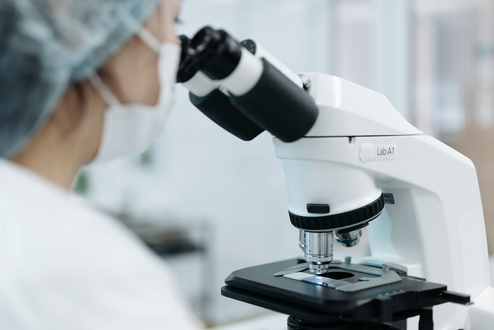 Medical laboratory technician using a microscope